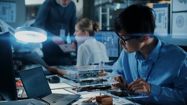 Two Talented Engineers Work with Three Dimensional Printer, They've Created Unique Component. They Work in a Creative Scientifically Advanced Laboratory.