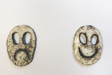 Happy  and sad ceramic face on white background, theater, carnival or duality concept