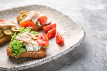 Plate with tasty chicken bruschettas, closeup