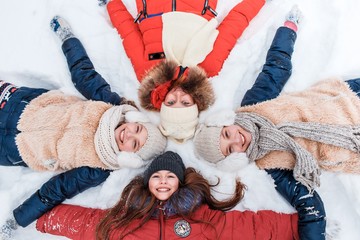 Beautiful teenage girls having fun outside in a wood with snow in winter on a wonderful frosty...