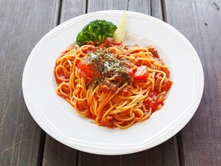 A plate of spaghetti bolognese on wooden table 