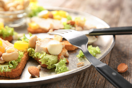 Plate with tasty chicken bruschettas, closeup