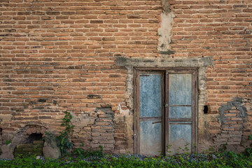 Fototapeta na wymiar Background of old vintage brick wall with old door