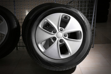 Car tire with rim indoors