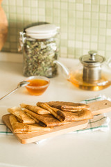 Russian pancakes with honey and tea