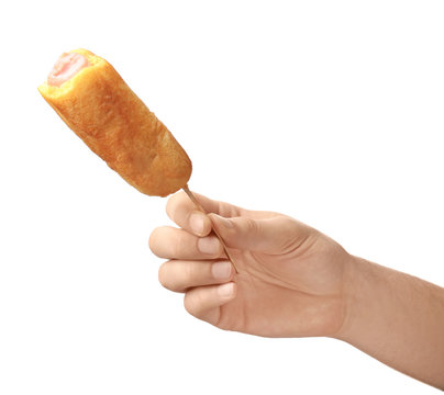 Woman Holding Tasty Corn Dog On White Background