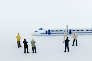 Miniature people: Businessman planning on a project for a train for traveling. Image use for transportation, business concept.