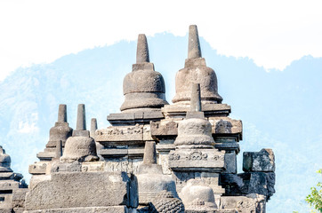 Ancient Buddha statue and stupa at Borobudur temple in Yogyakarta, Java, Indonesia.