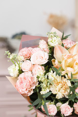 beautiful luxury bouquet of mixed flowers in woman hand. the work of the florist at a flower shop.