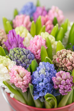 Fototapeta Flower shop concept. Mixed color. Fresh spring flowers in refrigerator room for flowers. Bouquets on shelf, florist business.
