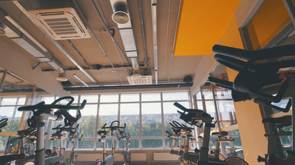 Bicycling simulators in the gym, interior of modern fitness club
