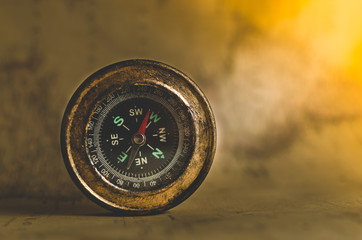 Compass on the background of old maps