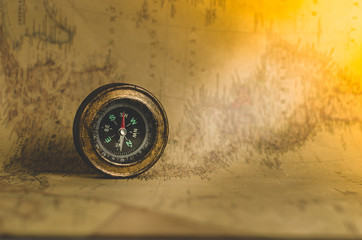 Compass on the background of old maps