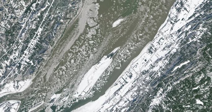 Very high-altitude overflight aerial of St. Lawrence River, Quebec, Canada, in winter. Clip loops and is reversible. Elements of this image furnished by USGS/NASA Landsat