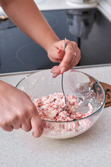 Mixing the cottage cheese and ingredients for making dietary of dessert, close-up.