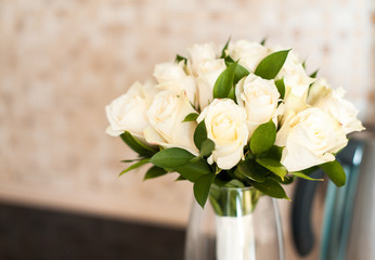 a bouquet of white roses in a vase