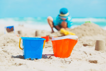 little boy play with sand on beach