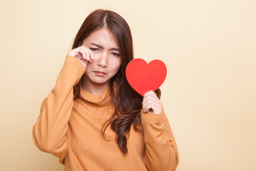 Asian woman sad and cry with red heart.