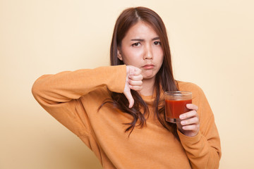 Asian woman thumbs down  hate tomato juice.