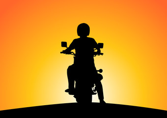 Fototapeta premium Silhouette of motorcyclists on nature at sunset.