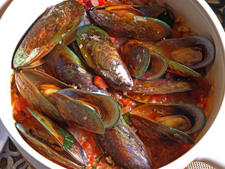 Mussels with white wine sauce on table  