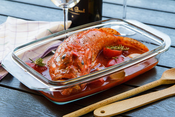 Whole fish in wine with clams in a roasting dish