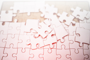 A white jigsaw puzzle is placed on it.