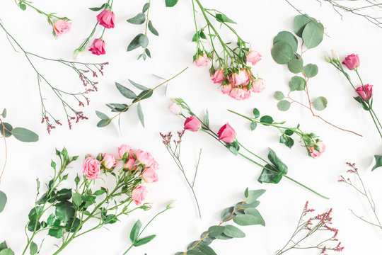 Flowers composition. Pattern made of various pink flowers and eucalyptus branches on white background. Flat lay, top view