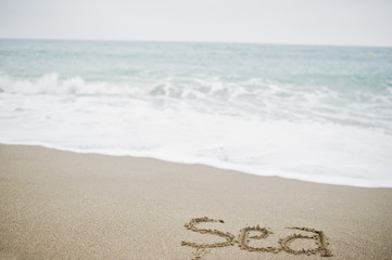 Close-up photo of sand inscription 