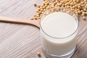 Closeup of soybeans and soy milk in a glass. 
