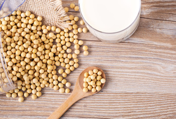 Top view of soybeans and soy milk in a glass on table