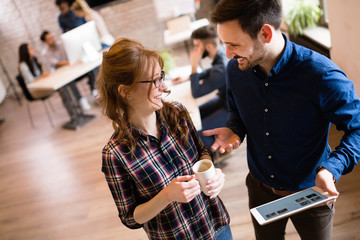 Portrait of young architects discussing in office