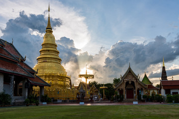 Fototapeta premium Wat Phra That Hariphunchai at sunset time in Lamphun Province, Thailand. Most famous temple in northern of Thailand.