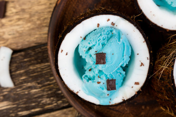 Blue ice cream in coconut bowl.