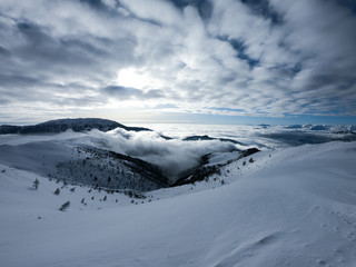 Fototapeta na wymiar Italian Alps In Winter. Cloudy and Snowy Nature