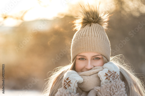 Portrait Of Young European Woman With Long Hair In Beige Hat With Fur Pompon Scarf Coat White Gloves At Sunny Winter Day Female Wrap In And Holding Portrait Of Young European Woman With Long Hair In Beige Hat With Fur Pompon Scarf Coat White Gloves At Sunny Winter Day Female Wrap In And Holding