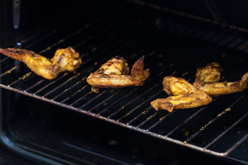Grilled chicken wings on a metal grill