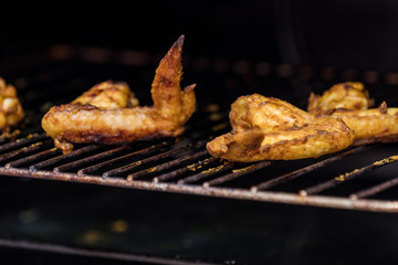  Roasted chicken wings on grill in the oven.