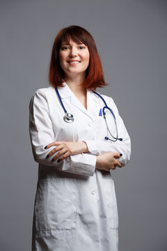 Photo of female doctor in white lab coat and with phonendoscope