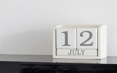 White block calendar present date 12 and month July