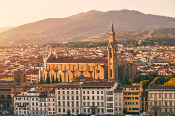 Fototapeta premium Panorama of Florence at sunset with the Basilica di Santa Croce (Basilica of the Holy Cross) illuminated by the setting sun. Basilica of the Holy Cross in sunset time.