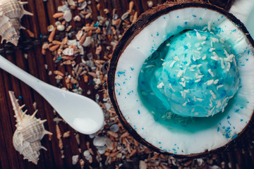 Blue ice cream in coconut bowl.