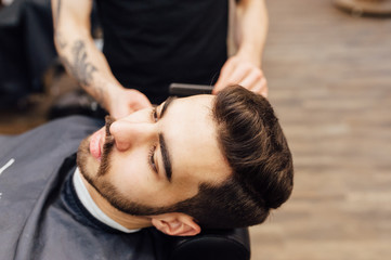Barber shave and modeling beard at the hair salon