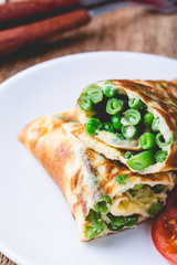 Egg omelet roll with  green beans and peas filling