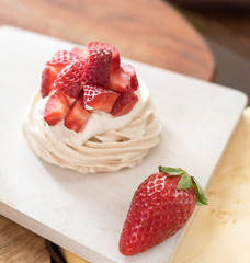 small meringue Pavlova dessert with strawberry