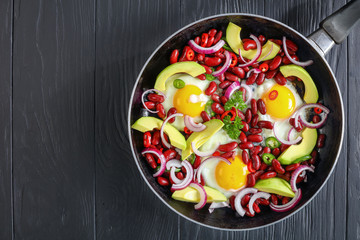 mexican breakfast with fried egg, beans, avocado