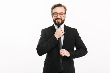 Happy young businessman standing isolated