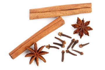Cinnamon sticks with star anise and clove isolated on white background. Top view