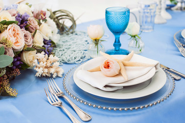 Beautiful decorated table set for wedding party. Old-fashioned wedding decorations with flowers. Rustic retro classical style