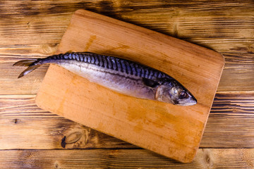 Salted scomber fish on a cutting board. Top view
